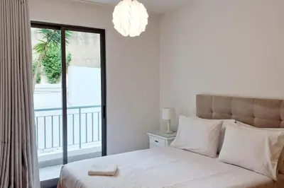 a bedroom with a large bed and a balcony at Ocean Pearl Apartment K in Funchal