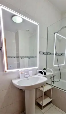 a bathroom with a white sink and a mirror at Ocean Pearl Apartment K in Funchal