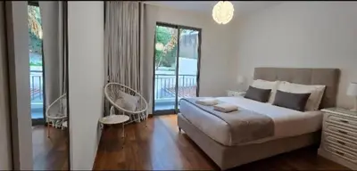 a bedroom with a large bed and a balcony at Ocean Pearl Apartment K in Funchal
