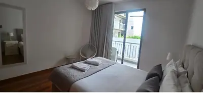 a bedroom with a bed and a couch and a window at Ocean Pearl Apartment K in Funchal