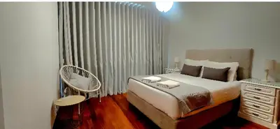 a bedroom with a bed and a chair in it at Ocean Pearl Apartment K in Funchal