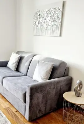 a gray couch in a living room with a table at Ocean Pearl Apartment M in Funchal