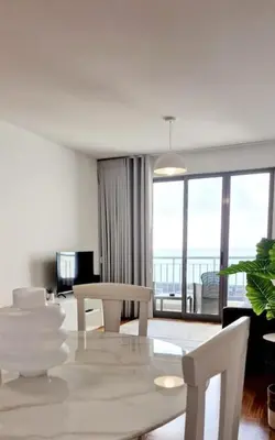 a living room with a table and chairs with a view at Ocean Pearl Apartment M in Funchal