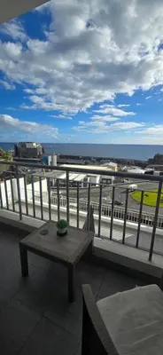 a balcony with a table and a view of a train at Ocean Pearl Apartment M in Funchal
