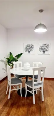 a white dining room with a white table and chairs at Ocean Pearl Apartment M in Funchal
