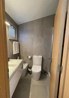 a bathroom with a toilet and a sink at Casa Sagres T2 - 3 minutos a pé Praia da Mareta in Sagres