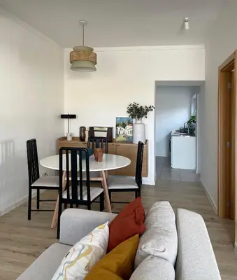 a living room with a couch and a table at Casa Sagres T2 - 3 minutos a pé Praia da Mareta in Sagres
