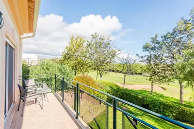 a balcony with benches and a view of a golf course at Fairviews Village - Boavista Resort in Lagos in Lagos