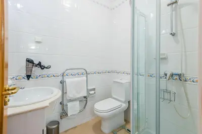 a bathroom with a toilet and a sink and a shower at Fairviews Village - Boavista Resort in Lagos in Lagos