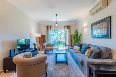 a living room with a blue couch and chairs at Fairviews Village - Boavista Resort in Lagos in Lagos