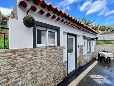 a white house with a brick wall at Modern Minimalist Studio with Essential Comfort in Funchal