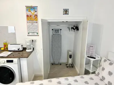 a kitchen with a washer and dryer in a room at Modern Minimalist Studio with Essential Comfort in Funchal