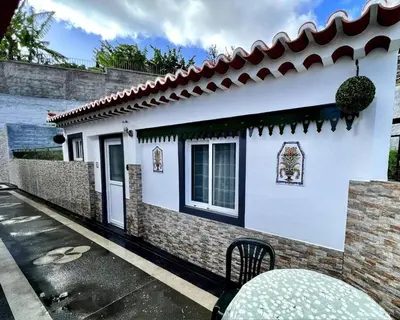 a white house with a tile roof at Modern Minimalist Studio with Essential Comfort in Funchal