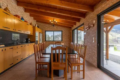 a kitchen with a table and chairs in a room at Gran Horizonte House by Holiday Rental Madeira in Ribeira Brava