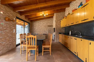 a kitchen with a table and chairs in a room at Gran Horizonte House by Holiday Rental Madeira in Ribeira Brava
