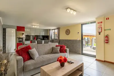 a living room with a couch and a table at Gran Horizonte House by Holiday Rental Madeira in Ribeira Brava