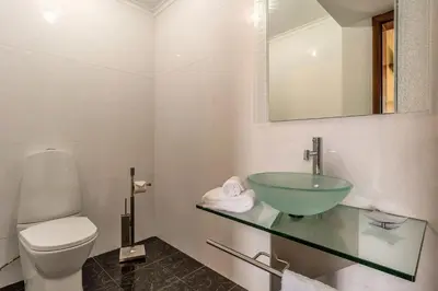 a bathroom with a sink and a toilet and a mirror at Gran Horizonte House by Holiday Rental Madeira in Ribeira Brava