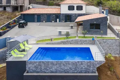 an overhead view of a swimming pool in front of a house at Gran Horizonte House by Holiday Rental Madeira in Ribeira Brava