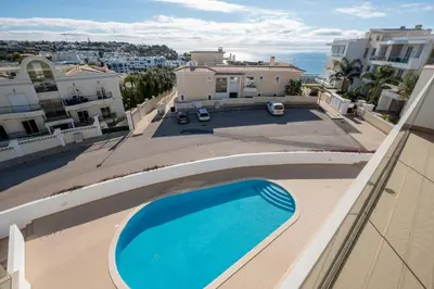 a view of a swimming pool from the balcony of a house at Porto de Mos 105 by Destination Algarve in Lagos