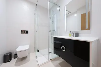 a bathroom with a toilet and a glass shower at Porto de Mos 105 by Destination Algarve in Lagos