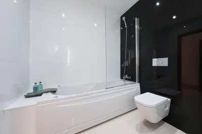 a white bathroom with a toilet and a shower at Porto de Mos 105 by Destination Algarve in Lagos