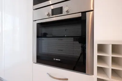 a microwave oven sitting inside of a white cabinet at Porto de Mos 105 by Destination Algarve in Lagos