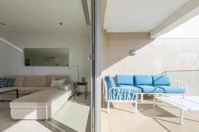 a living room with a couch and a table at Porto de Mos 105 by Destination Algarve in Lagos