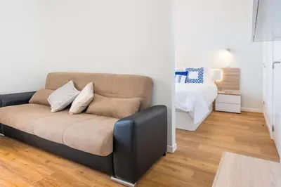 a living room with a couch and a bed at Modern and cozy Apartment in Funchal