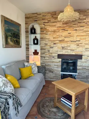 a living room with a couch and a fireplace at Casa Pedro in Salema - Oceanview & beach in Salema
