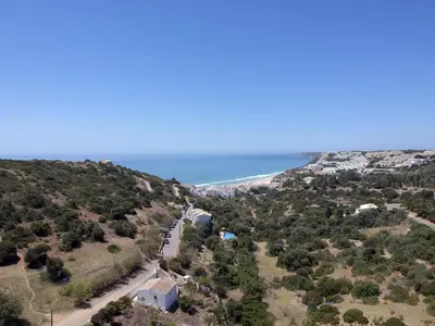 a view of the beach from the top of a hill at 401 Villa Salemar in Salema