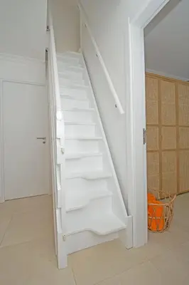 a white staircase in a room with an open door at 401 Villa Salemar in Salema
