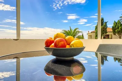 a bowl of fruit sitting on top of a table at Lido Sunset, a Home in Madeira in Funchal