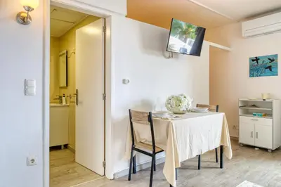 a dining room with a table and chairs at Lido Sunset, a Home in Madeira in Funchal