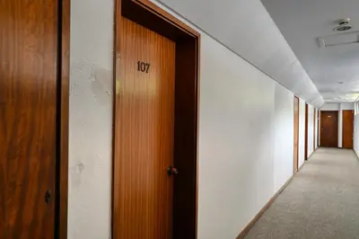 a hallway with a wooden door with the word ivy on it at Lido Sunset, a Home in Madeira in Funchal