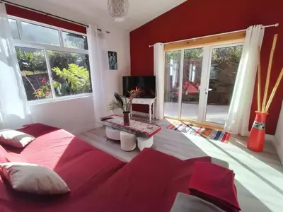 a red bedroom with a bed and a television at Sea Mountain House in Machico