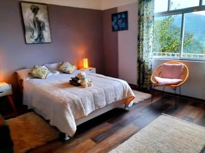 a bedroom with a bed with a teddy bear on it at Sea Mountain House in Machico