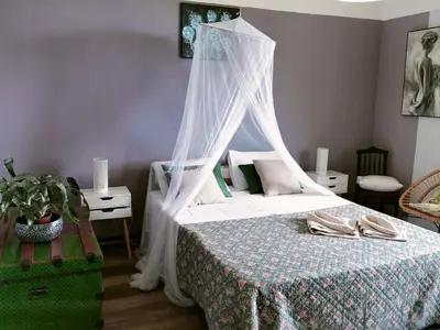 a bedroom with a bed with a canopy at Sea Mountain House in Machico