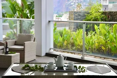 a living room with a large window and a table at Peaceful Madeira Palace in Funchal