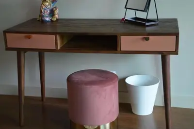 a wooden desk with a pink stool and a table with a stool at Peaceful Madeira Palace in Funchal