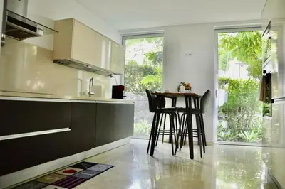 a kitchen with two stools and a table in it at Peaceful Madeira Palace in Funchal