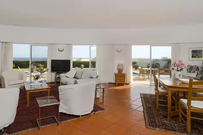a living room with a couch and a table at Villa Camena, private pool, sea view, residential area outside of the village Praia da Luz in Luz