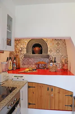 a hat sitting on top of a bed at Casa das Rosas e Casa Do Mar in Arco da Calheta