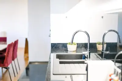 a kitchen with a sink and two faucets at Magic Home, everything you need. in Funchal
