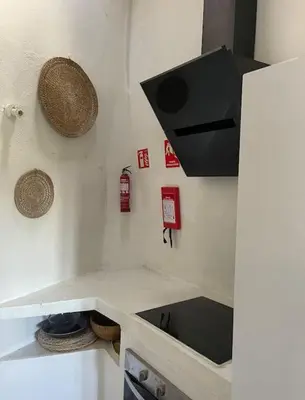 a kitchen with a sink and a counter top at Casa da Estrelinha in Carrapateira
