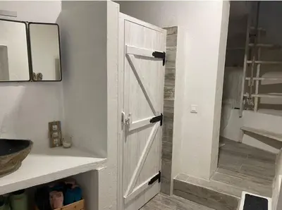 a bathroom with a white cabinet with a door at Casa da Estrelinha in Carrapateira
