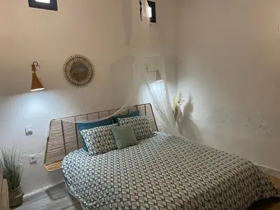 a bedroom with a bed and a mirror on the wall at Casa da Estrelinha in Carrapateira