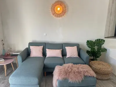a living room with a blue couch with pink pillows at Casa da Estrelinha in Carrapateira