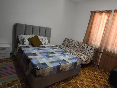 a bedroom with a bed and a couch in it at Slice of Paradise- Palheiro de Golf in Funchal