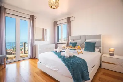 a bedroom with a bed with a view of the ocean at Paradise View by Atlantic Holiday in Funchal