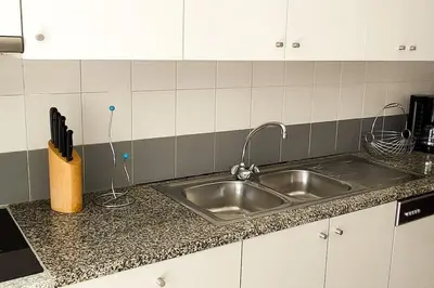 a kitchen counter with a stainless steel sink at Jardim Sol Holiday Apartment in Funchal